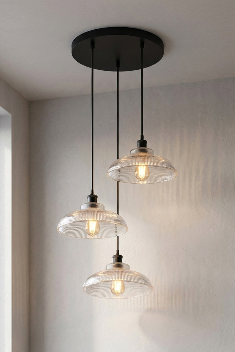 Three holophane-style glass shades together on a single black circular rose to form this Multi Light Pendant