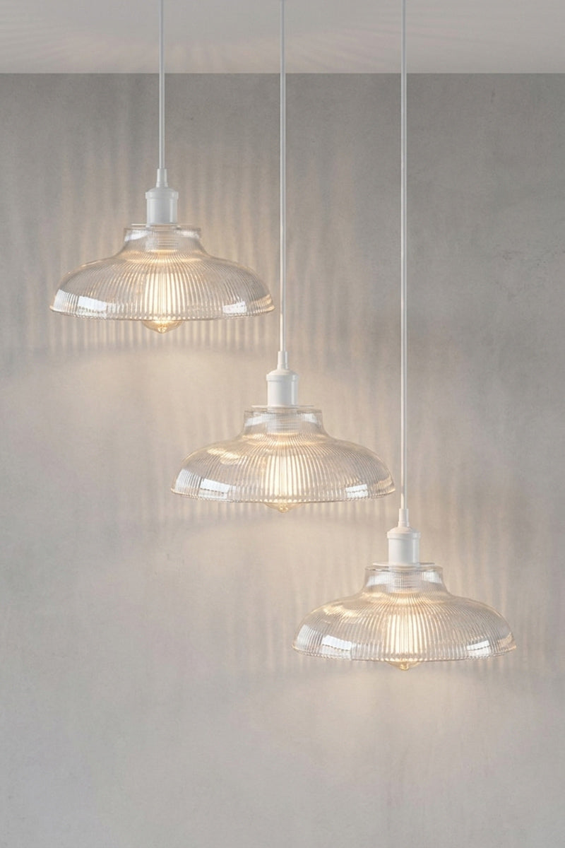 Three clear ribbed glass pendant light shades hanging at different heights on this Multi Light Pendant