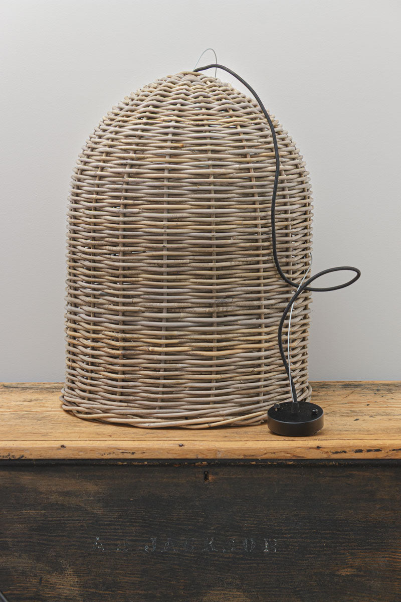 Uninstalled rattan bell shaped pendant light with wire and black fabric cord suspension