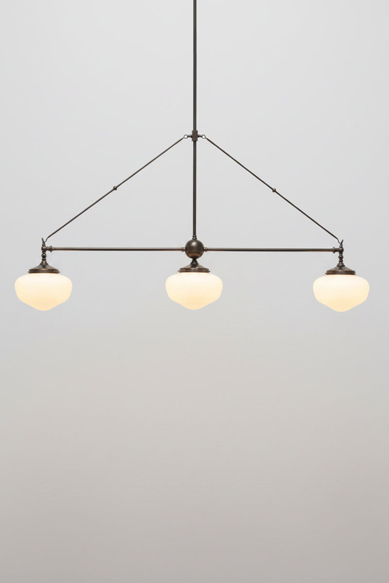 Opal glass chandelier on a brass fitting with three classic schoolhouse shades 