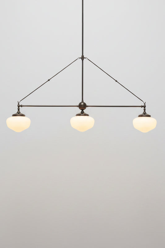 Opal glass chandelier on a brass fitting with three classic schoolhouse shades 