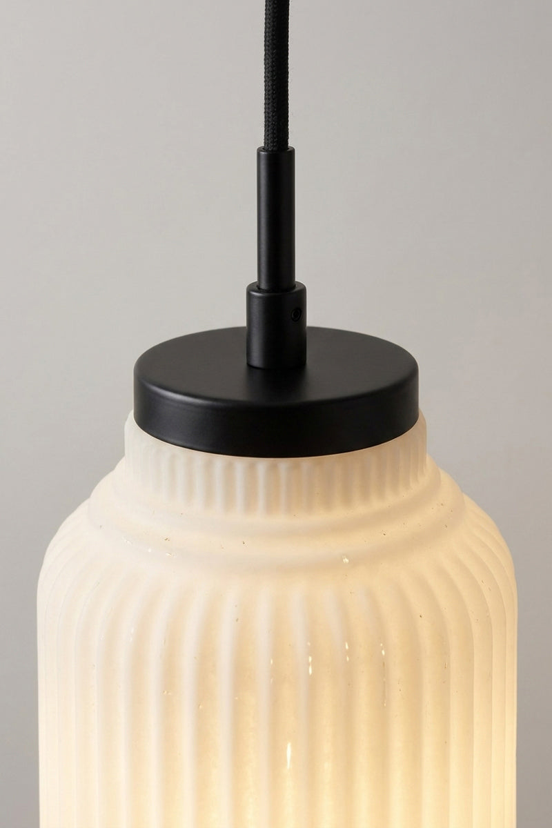 close up of Forum Glass Pendant Light with ribbed detailing on opal glass