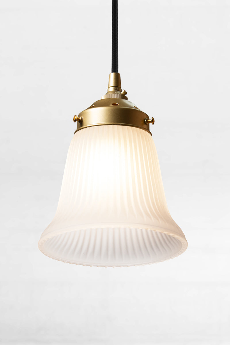 Delicate ribbed opal glass shade on a gold/brass pendant cord. 