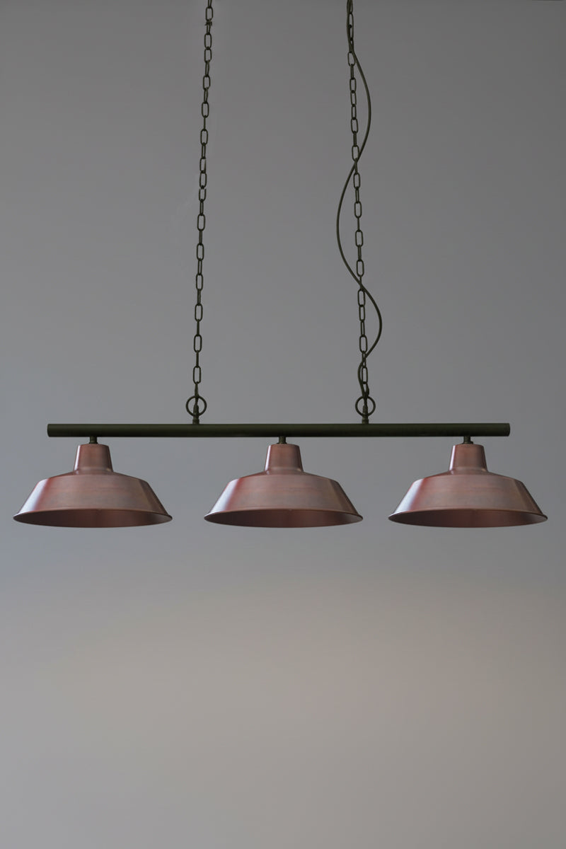 Vintage-style swing pendant light with three solid copper shades on black fitting