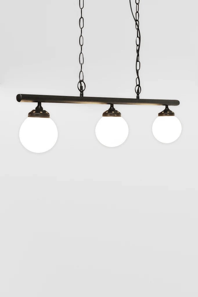 Angeled view of the Small opall shades on the three light linear bar light with black chains. 