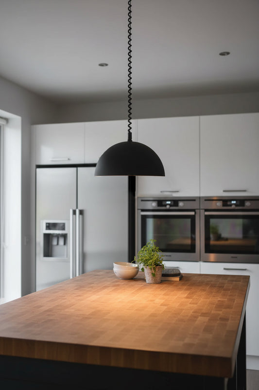 Modern kitchen with wooden island, and black dome pendant light