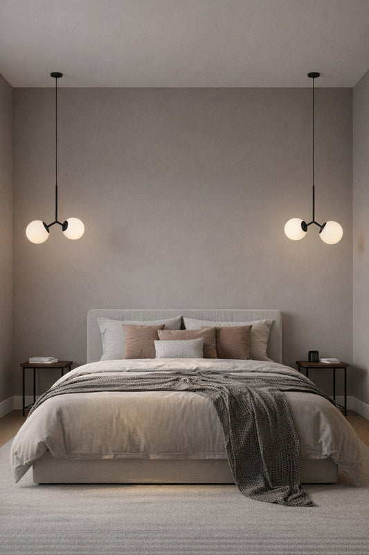 double glass pendant light in bedroom over side tables.