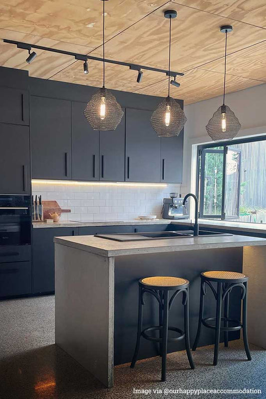 Three small black mesh pendant over kitchen island
