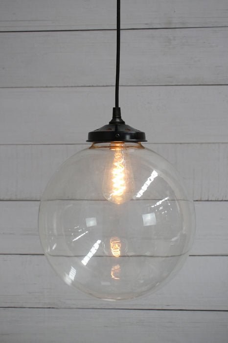 Black round cord pendant light with large clear shade