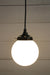 Black round cord pendant light with small opal shade