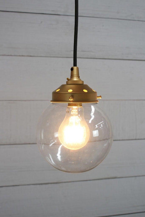 Gold brass round cord pendant light with small clear shade