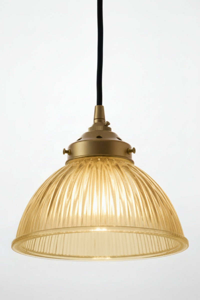Amber ribbed glass shade on the gold/brass pendant cord. 