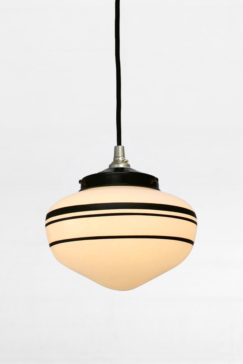 Small opal glass shade with three black hand painted stripes with a gold/brass pendant cord and black gallery. 