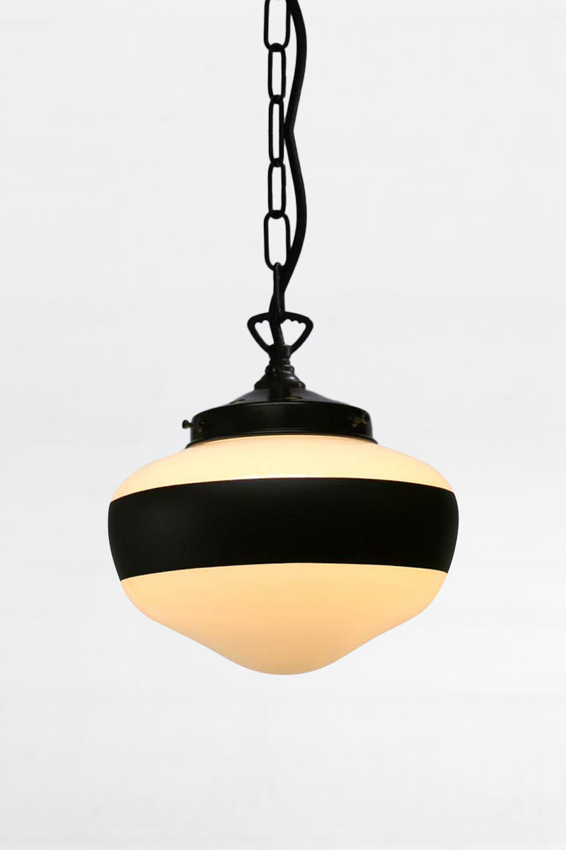 Small opal glass shade with a large black stripe on a black chain and cord pendant. 