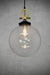 large clear glass pendant with gold brass disc cord