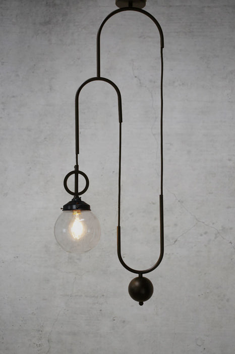 Clear pendant light with black pulley cord without disc