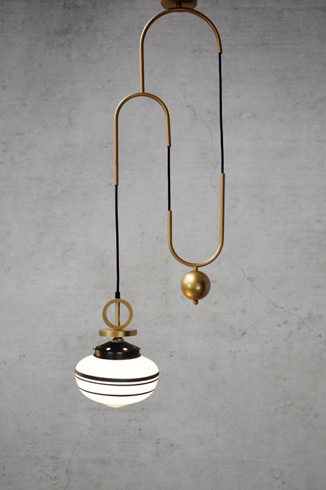 Opal glass three stripe pendant light with gold brass cord and disc