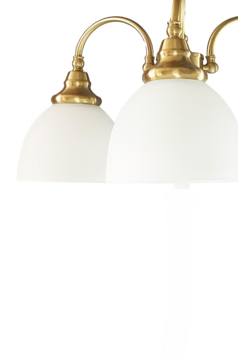 Satin Brass 3 light with opal shades facing down. 