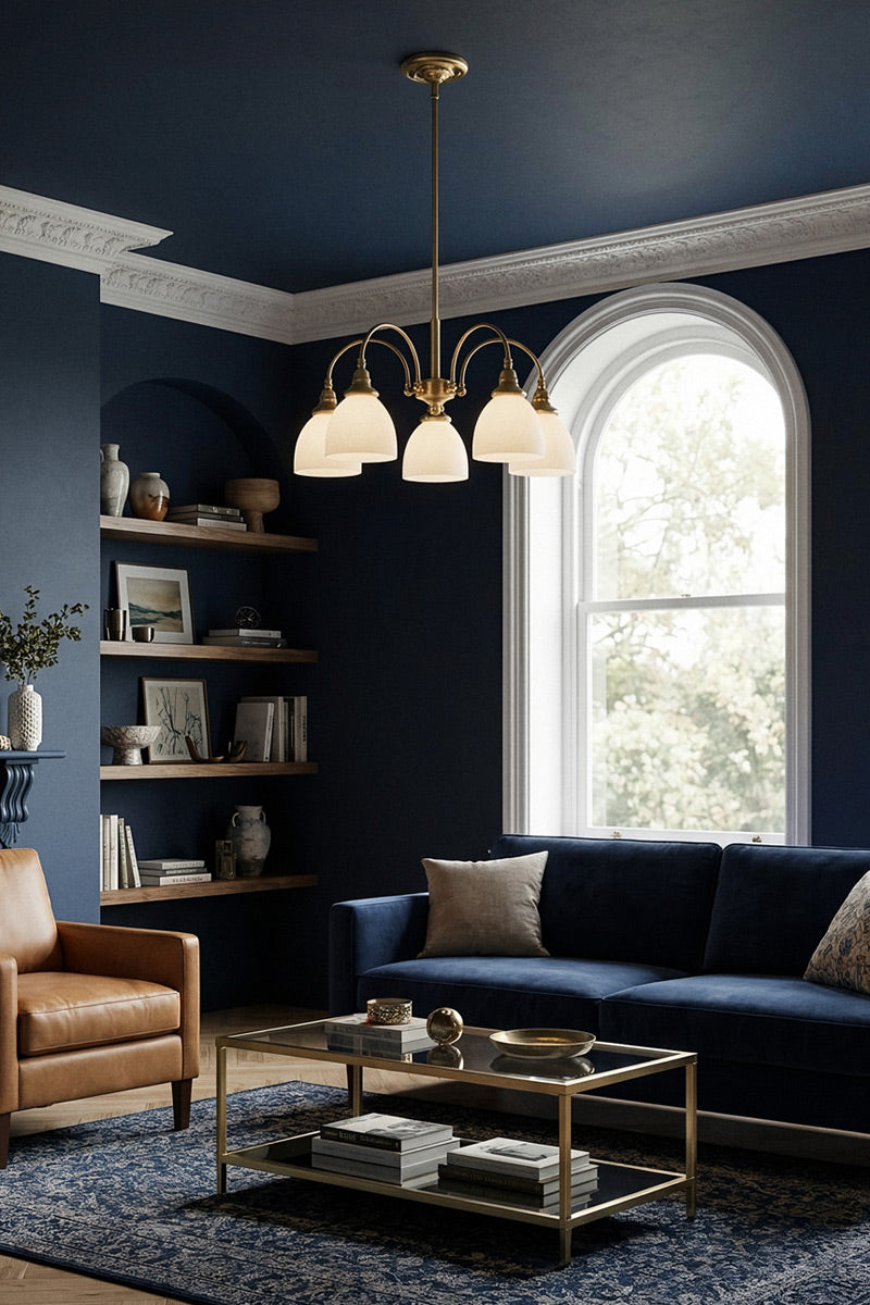 Large 5 light Satin Brass chandelier, with gooseneck arms and opal glass shades in a navy living room. 