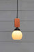 small open glass pendant with wooden block cord