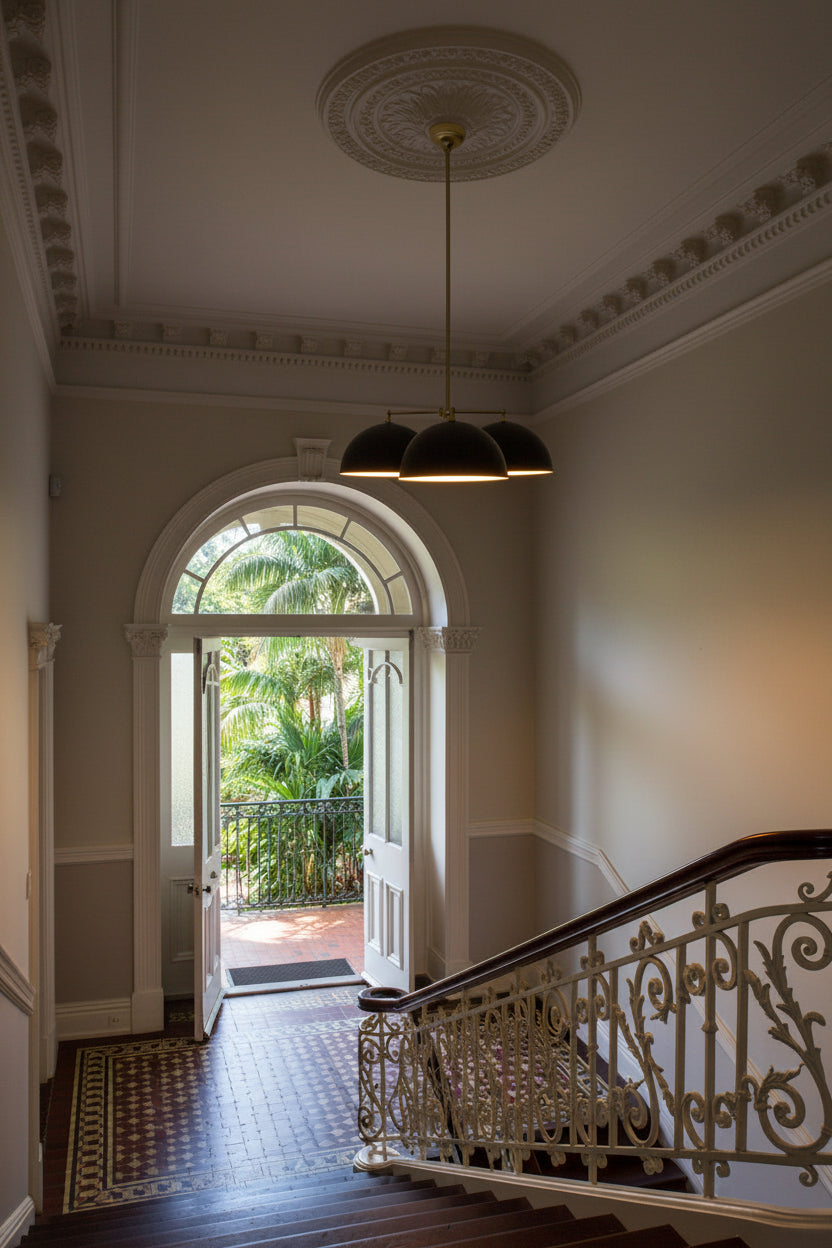 stair case with 3 light pendatn in it.