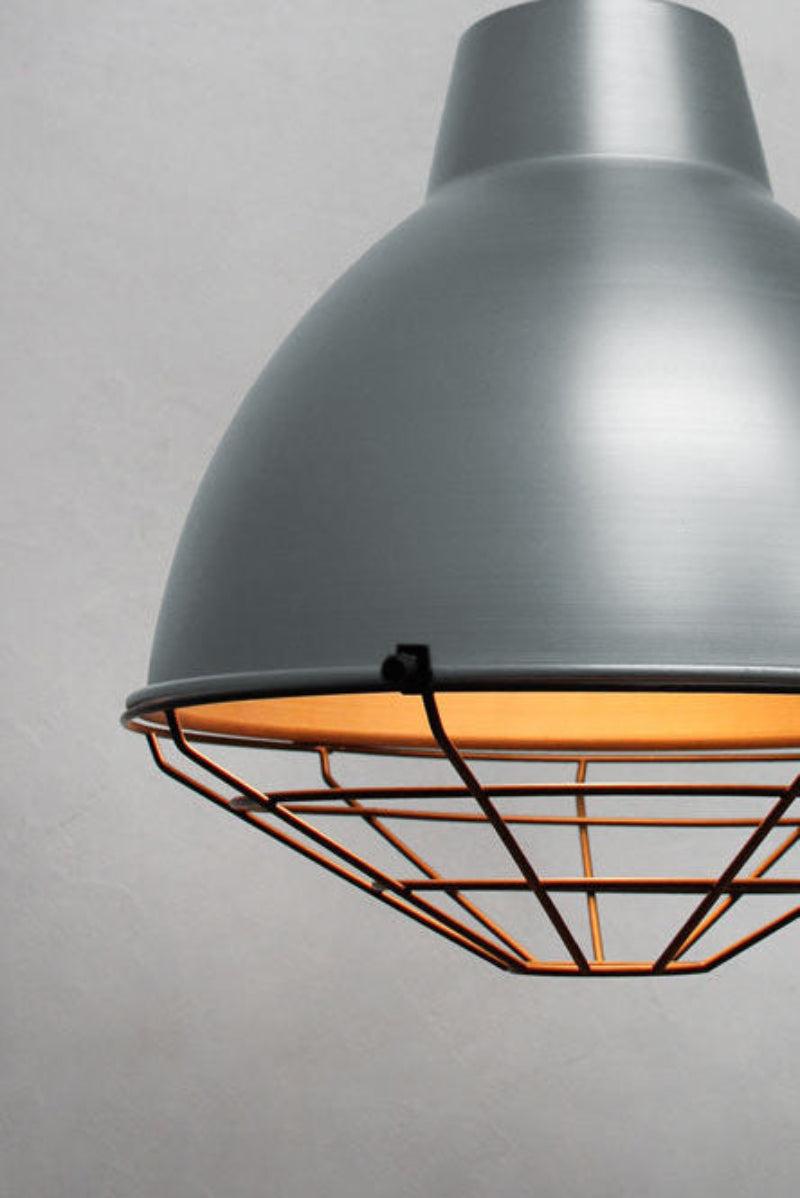 Vintage steel loft shade with a black cage guard