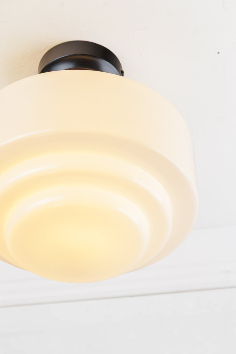 Close up of the opal glass shade with stepped silluette. 