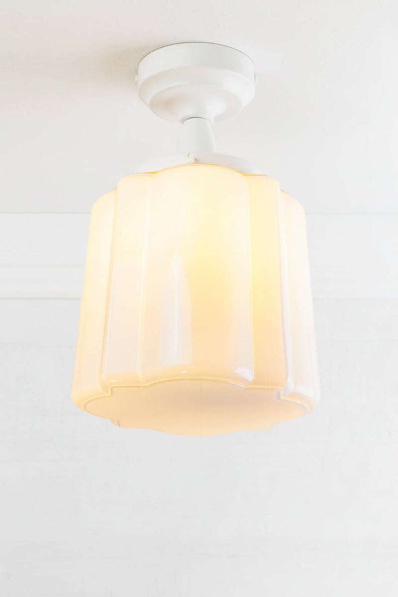 Opal curved glass shade with distinctive deco scalloped detailing, paired with a white batten holder and gallery