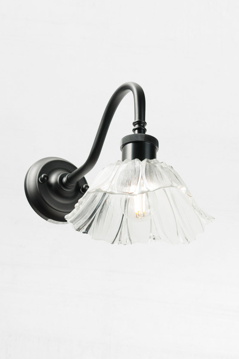 a petite, weighty clear glass shade with sculptured detailing.