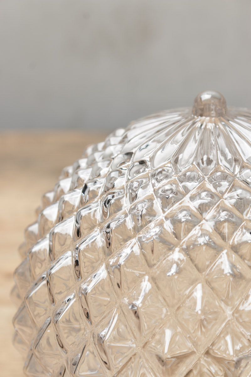 Close up of the clear glass shade with a vintage textured design. 