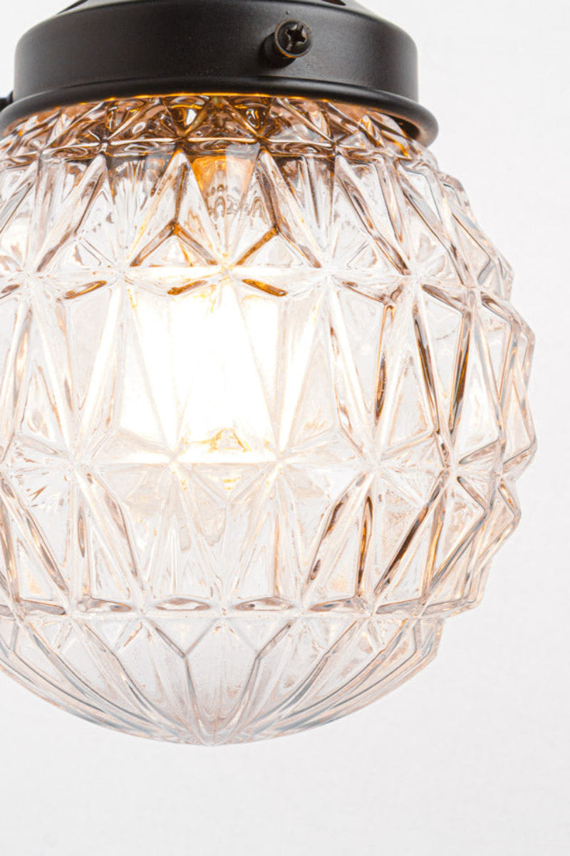 Close up of the gemetric vintage design of the clear glass shade. 