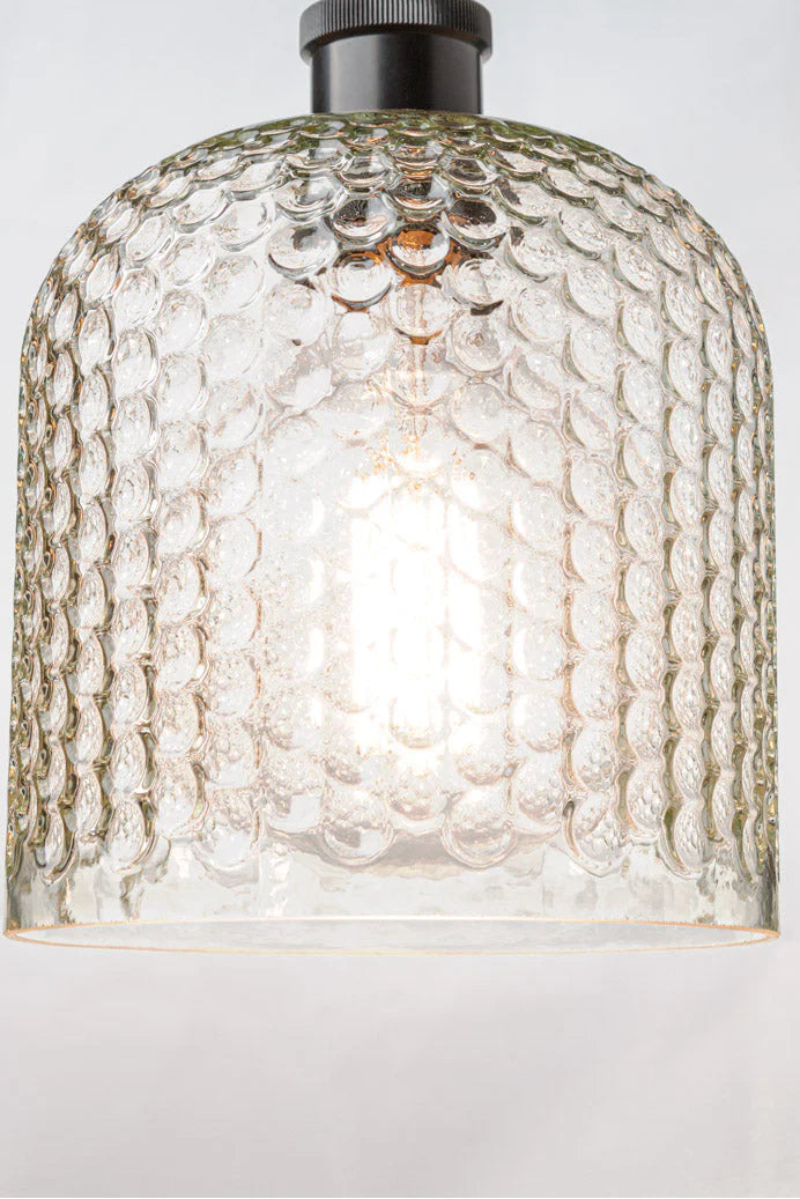 glass shade offers a dimpled texture and on a black flush mount