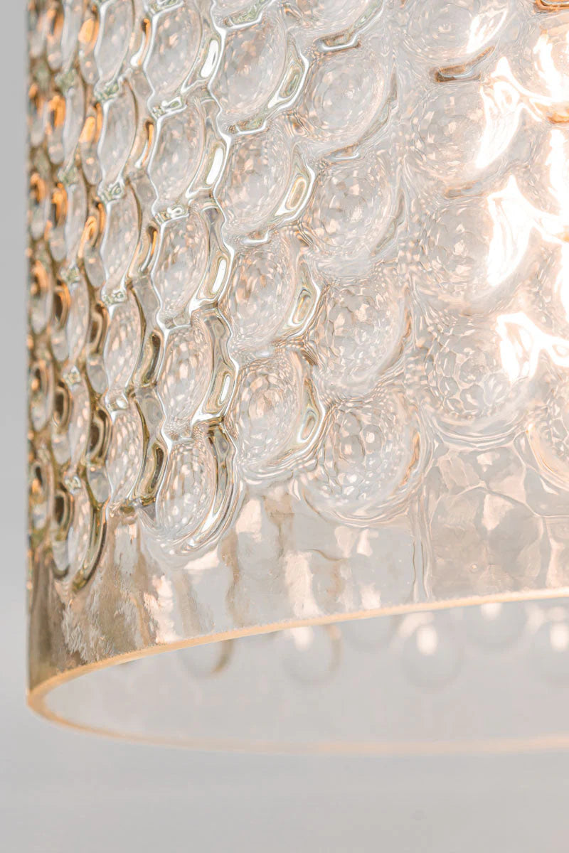 The clear glass shade offers a distinctive dimpled texture and design
