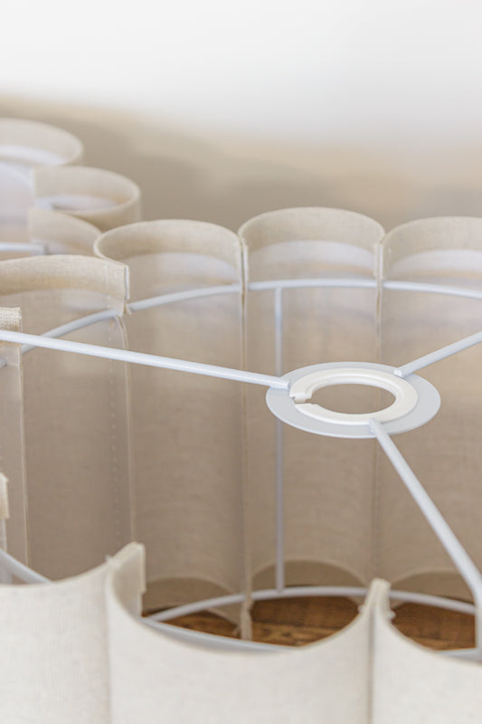  rounded cylindrical fabric panels extending from a white metal frame