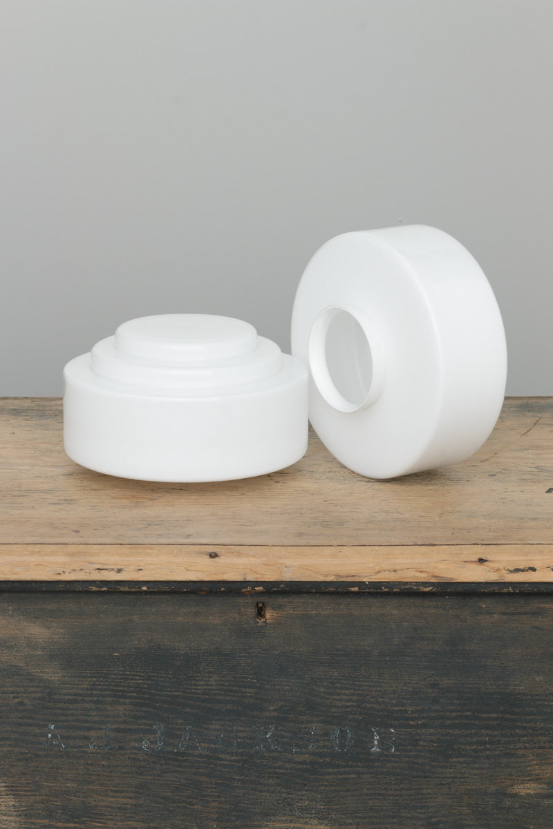 Uninstalled Regis opal glass shade with stepped Deco silhouette displayed on timber surface