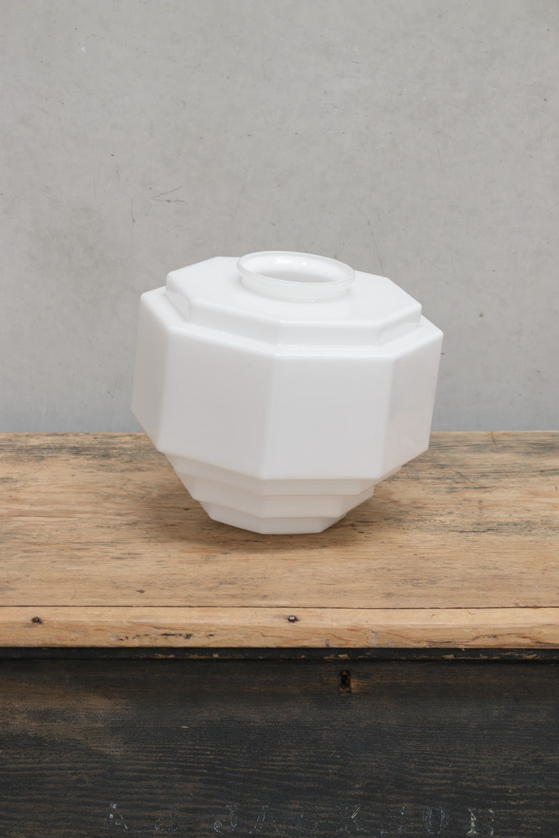 Opal glass shade with angular geometry provides a diffused light when illuminated