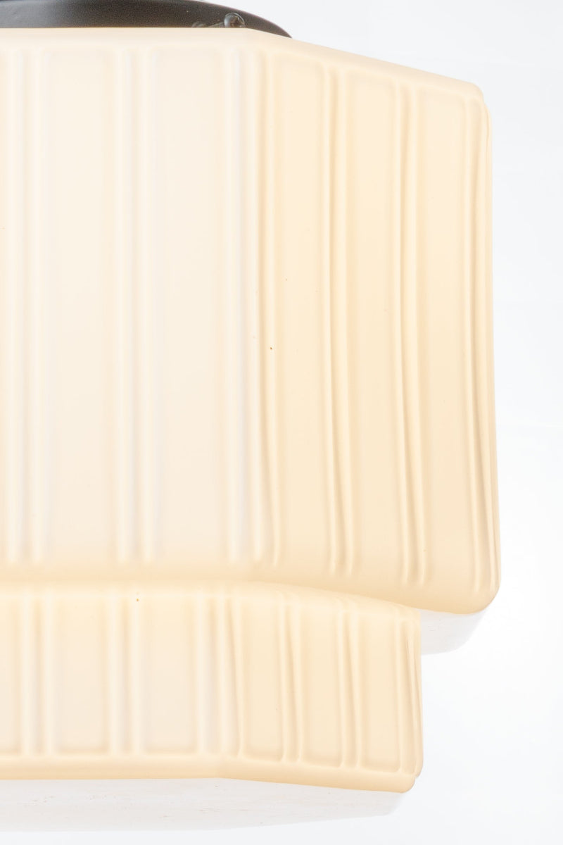 Opal glass shade with angular geometry and a signature fluting