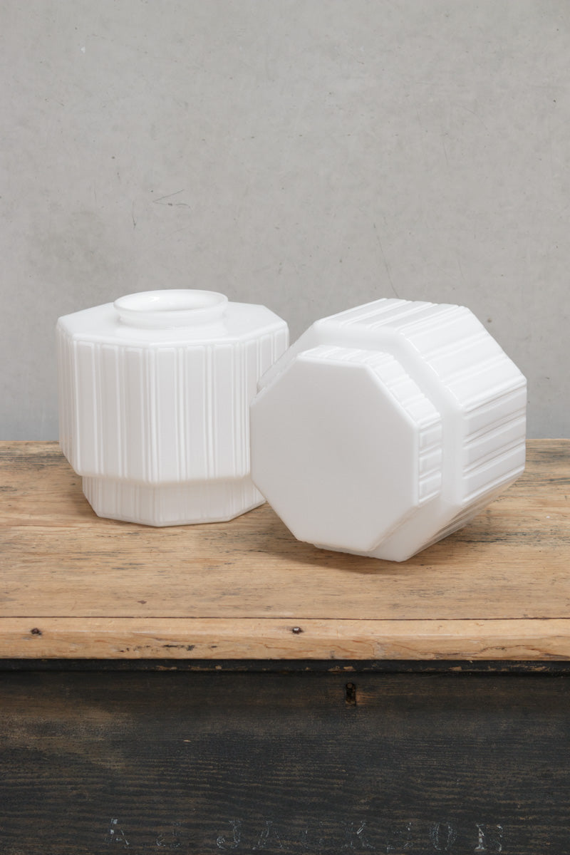 Two opal glass shades on a timber bench