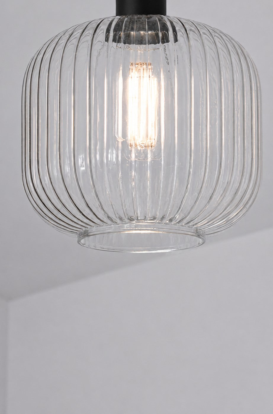 Close-up of clear reeded glass shade illuminated on Balmain Flush Mount