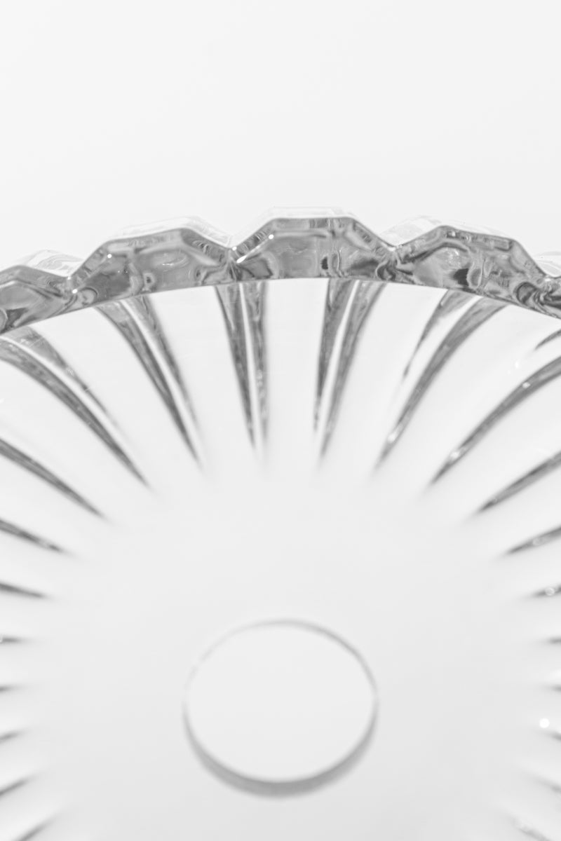 Close up of the edge of the fluted design of the clear glass shade. 
