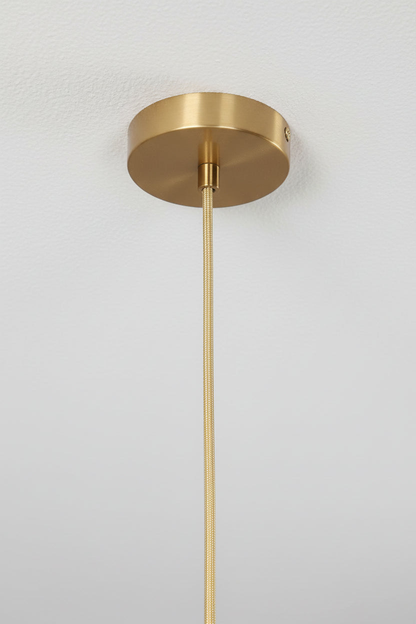 Close up of gold ceiling rose and fabric cord