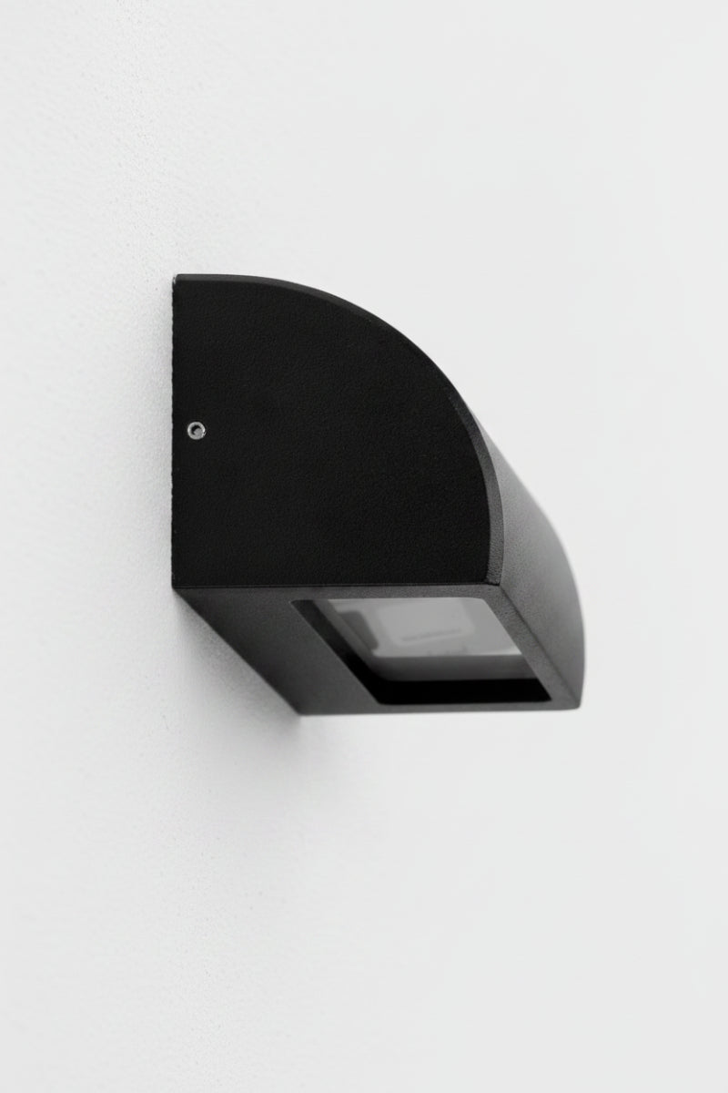 Large matt bacl curved step wall light, with a clear diffuser. 