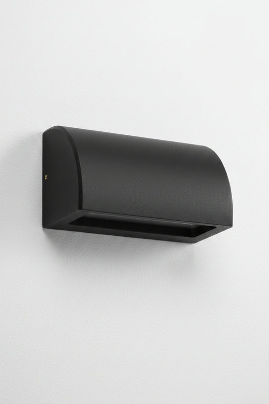 Large curved matt black step light with a downward light on a white exterior wall. 