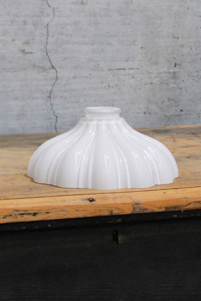 Small opal shade that has vintage detailing and a curved cone shape. 