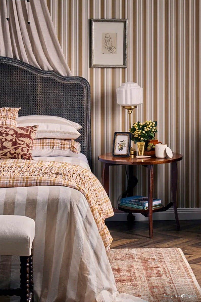 Image via @bbgaus: Gold/brass candlestick table lamp with opal glass deco shade in a beautifully styld traditional bedroom with striped wall paper. 