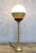 Crown Sphere Table Lamp with a gold lamp holder, black gallery and a gold and opal shade