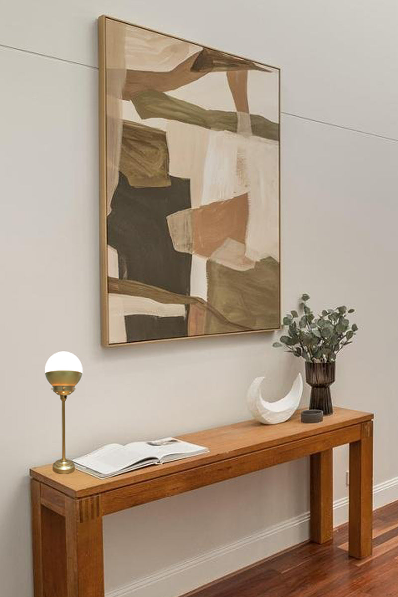 Gold/Brass crown shade table lamp on entrance table. 