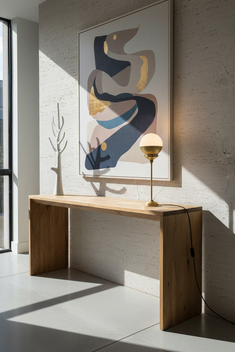 Gold/Brass crown shade table lamp on entrance table. 