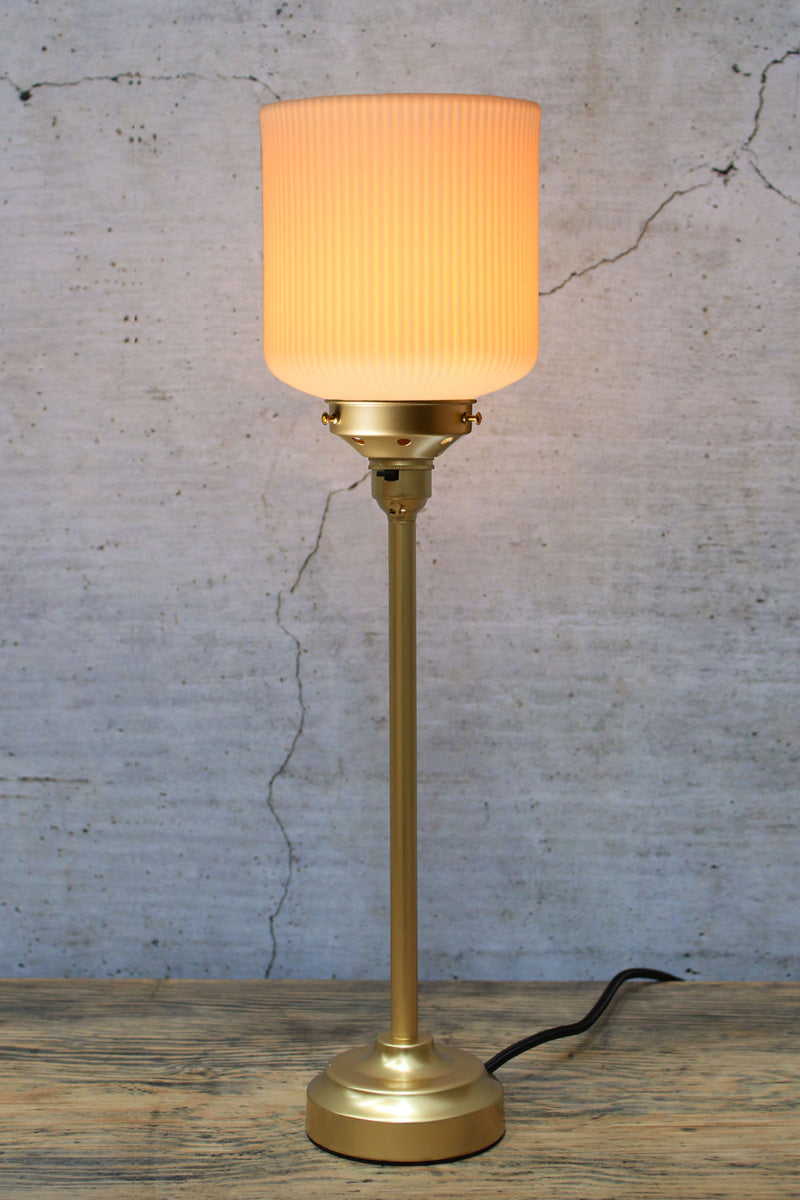 Ribbed ceramic shade with a gold/brass candlestick lamp base
