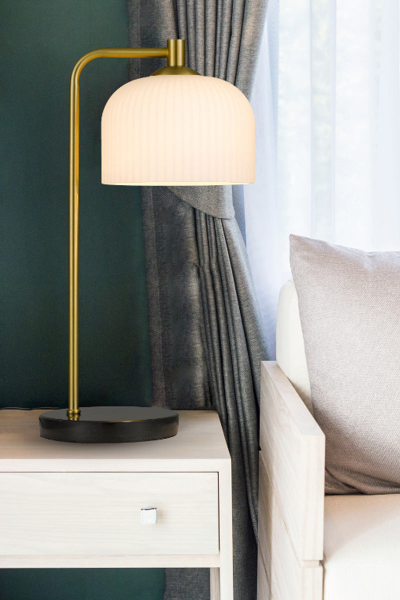 Elegant table lamp with a ribbed opal glass shade, antique brass iron stande and solid marble base in black.